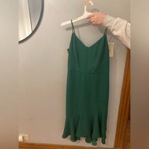This is a beautiful emerald green midi Banana Republic dress.